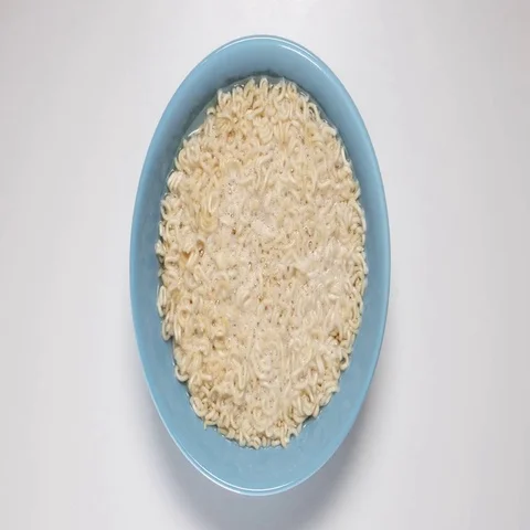 TIME-LAPSE: Preparing a quick noodles in blue bowl (top view) Stock Footage 69476934
