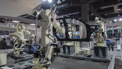 Time lapse of production robots assembling cars, technology trade show China Stock Footage 71527221