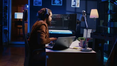 Time lapse of programmer typing complex code in neon lit home office Stock Footage 265346698