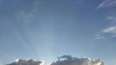 Time Lapse of puffy clouds and sunbeams at dusk Stock Footage 346788541