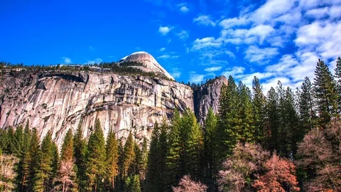 Time Lapse - Puffy Clouds Moving over Mountain Top in Yosemite National Park Stock Footage 73470602