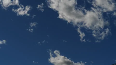 Time lapse of puffy cumulus clouds against a blue sky Stock Footage 136716766