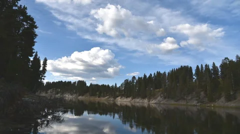 Time lapse of puffy white clouds over the Yellowstone River Stock Footage 53808643