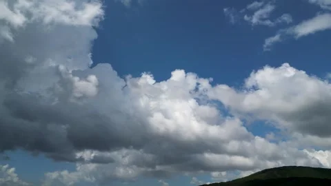 Time-lapse of Puffy White Clouds Moving in Blue Sky Stock Footage 321231729