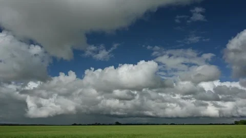Time lapse of puffy white summer clouds in a dark blue sky  Stock Footage 273346343