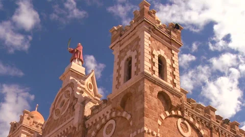 A time lapse pull back as clouds drift over a Catholic Maronite Church. Stock Footage 34428352