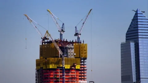 Time lapse of quickly moving construction cranes atop skyscraper. Stock Footage 78815791