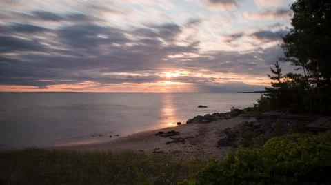 Time Lapse Racing Clouds, Sunset, Sunrays, Sea and Beach Stock Footage 48651397
