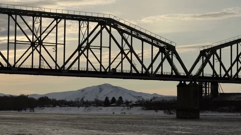 Time lapse of railway bridge over the river at dawn with a mountain forest in Stock Footage 75287169