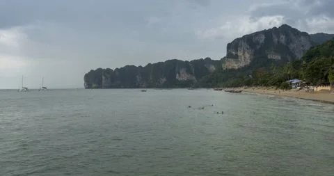 Time lapse of rain clouds over beach and sea landscape with boats. Tropical Stock Footage 139980386