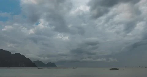 Time lapse of rain clouds over beach and sea landscape with boats. Tropical Stock Footage 139980464