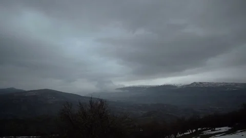 Time Lapse, Rain shafts, dark clouds, drop rain over foggy mountains Stock-Footage 77203628