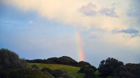 Time lapse of rainbow clouds sky and nature field at sunset Stock Footage 106309146