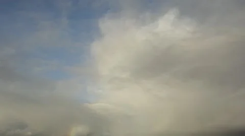 Time lapse rainbow forming in moving clouds Stock Footage 12163876