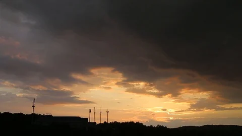 Time lapse rainy clouds close the sky and starting raining. Sunset. Stock Footage 108632192