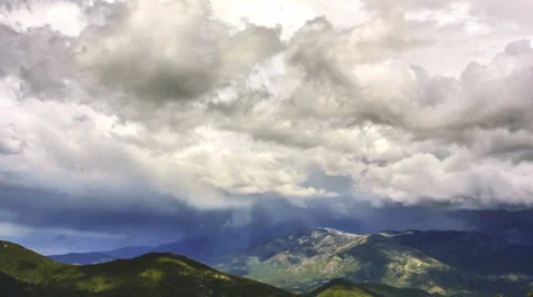 Time lapse of rainy clouds moving fast above green hills Stock Footage 38242307