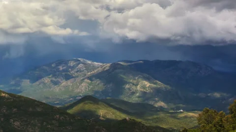 Time lapse of rainy clouds moving fast above green hills Stock Footage 38242360