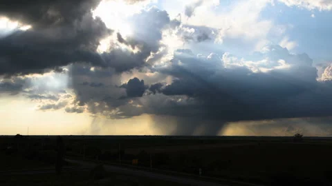 Time lapse of rainy clouds splitting up and letting the sun shine through Stock Footage 133413877