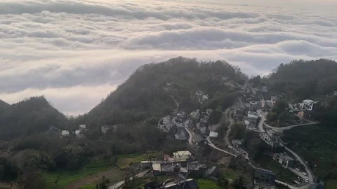 Time-lapse Rapid Sea of Clouds Flowing over a Mountain Village Stock Footage 330149970