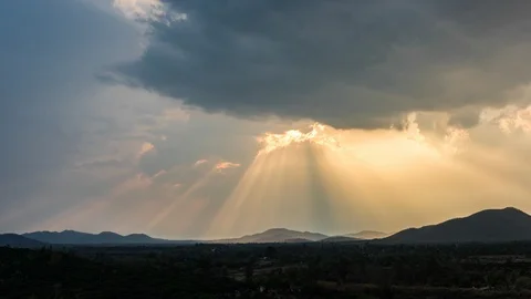 Time lapse : a rays light of sunset and rain above the hills (pan shot) Stock Footage 88576751