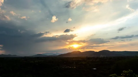 Time lapse: rays light of sunset and rain above the hills  Stock Footage 130848141