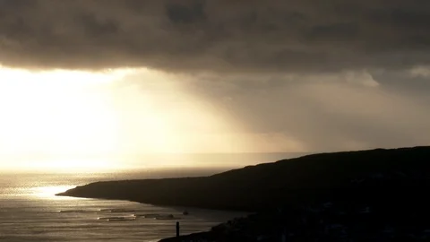 Time lapse rays of spot sun light shining from above moving clouds to sea waves Stock Footage 92642932