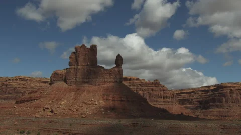 Time lapse of receding clouds casting shadows on Utah sandstone rock formations Stock Footage 197013478