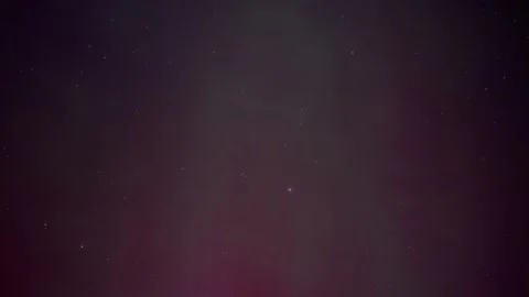 Time lapse of red and green Aurora dancing in a star filled sky with thin clouds Stock Footage 287958390