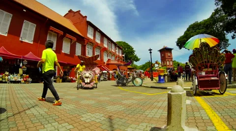Time lapse of red buildings in old Melaka with tourists and Rickshaw. Malaysia. Stock Footage 40052736