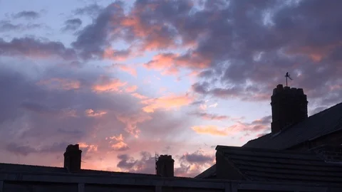Time lapse of red sky over chimneys of terrace houses England UK 4K Stock Footage 111219411