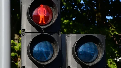 Time lapse red stop and green go warning symbols for pedestrians and cyclists UK Stock Footage 78632605