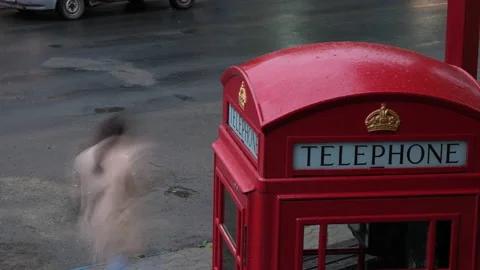 Time lapse. A red telephone booth .A view of a road with a red telephone booth.c Video stock 156414641