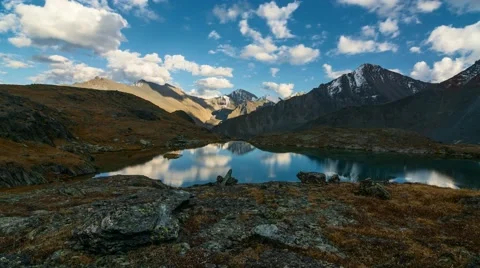 Time Lapse. Reflection of clouds in the mountainous lake. Stock Footage 68566870