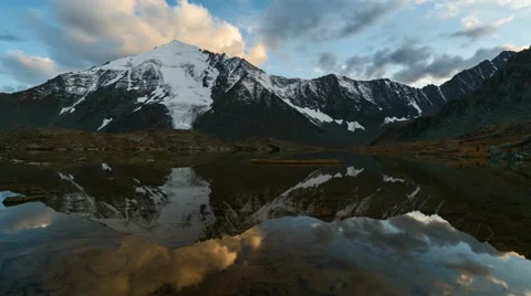 Time Lapse. Reflection of clouds on sunset in the mountainous lake. Stock Footage 68578720