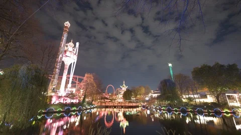 Time-lapse reflection of illuminated Tivoli Gardens on waterfront at night Stock Footage 116598237