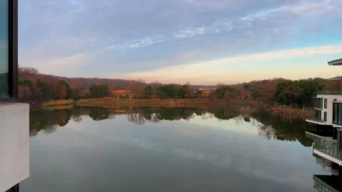Time lapse of reflections of the peaceful pond at sunrise in winter Stock Footage 297740628