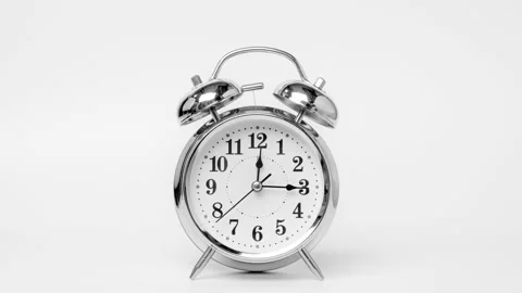 Time lapse of retro alarm clock running isolated on white background. Stock Footage 184377048