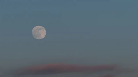 Time lapse. Rising full moon against the background of blue sky and pink sunset  스톡 동영상 258847519