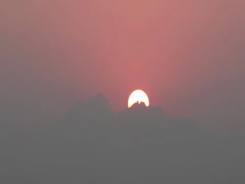 Time lapse of rising sun over mountain against blurred background : 4K footage Stock Footage 74069836