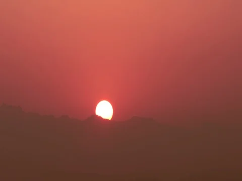 Time lapse of rising sun over mountain against red morning glow  : 4K footage Stock Footage 74753925