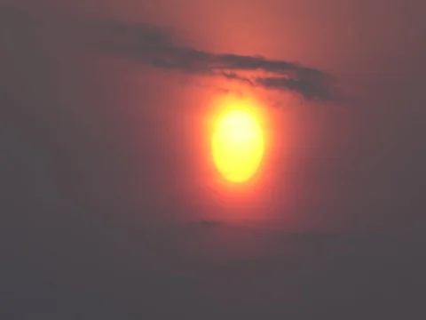 Time lapse of rising sun through clouds against morning glow : 4K footage Stock Footage 76120096