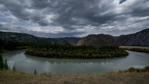 Time lapse river bend in summer. Clouds are running and sun is shining Stock Footage 100760243