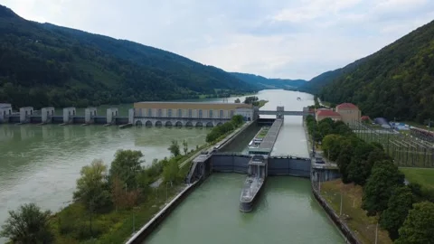 Time lapse of a river cruise ship descending in the lock at a hydropower plant Video stock 342421046