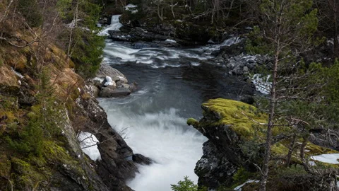 Time lapse of a river flowing through tough terrain on a bright spring day in Stock Footage 331778677