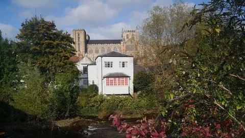 Time lapse river skell flowing by ripon cathedral yorkshire uk Stock Footage 119059875
