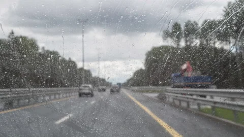 Time lapse road through windshield car window with going rain drops. Stock Footage 141841090