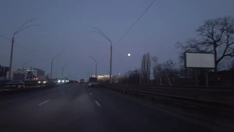 Time Lapse road view from a driving car in the early morning, bright moon at sky Video stock 148446487