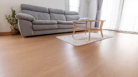 Time lapse of Robotic vacuum cleaner on laminate wood floor in living room Stock Footage 253630574
