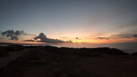 Time lapse on a rocky cliff during sunrise with fishermen boats Stock Footage 121467516
