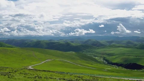 Time Lapse Rolling Green Mountain Grassland Winding Country Road Flowing Cloud Video stock 337980895